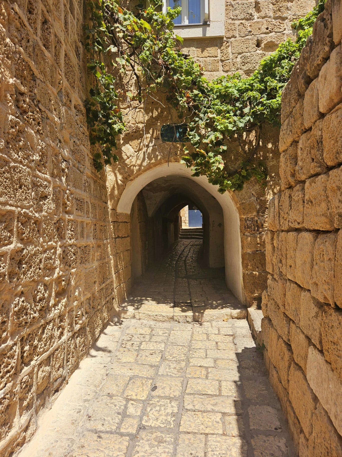 Lanterns and brass bowls in a Jaffa market alley